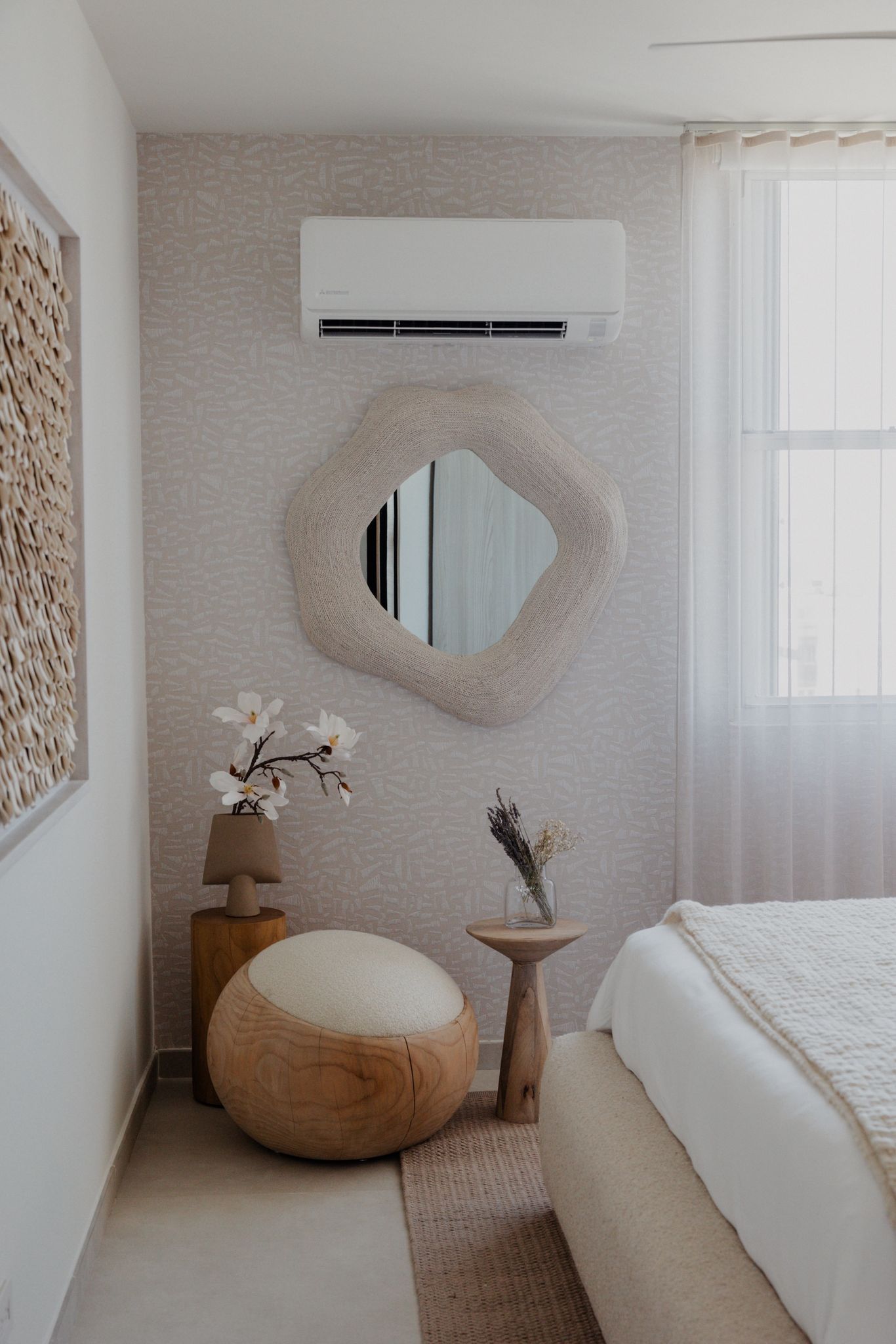 Walk-in shower in limestone with linen curtain.